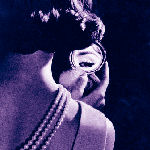 woman looking in compact mirror