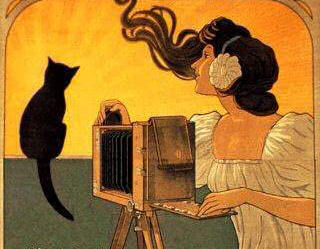 woman photographing cat