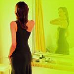 woman looking in mirror